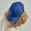 A navy cap with a structured design and a curved peak, featuring a logo on the front.