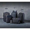 A collection of black bags, including backpacks, a wheeled suitcase, and a messenger bag, with a sleek design.