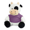 A plush cow toy in black and white, wearing a purple shirt, sitting with a cheerful expression.