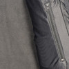 A close-up of a women's softshell jacket in black and grey, featuring a zippered pocket.