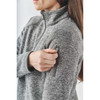 A women's Avalante full zip fleece jacket in grey, featuring a zippered sleeve pocket and a high collar.