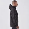 A men's softshell jacket in black, featuring a hood and a logo, displayed on a model from the side.
