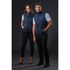 Two models wearing navy blue puffer vests, standing side by side against a dark background. The vests have a zip closure and a sleek design.