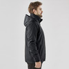 A black men's 3 in 1 jacket displayed on a model, featuring a hood and sleek design. The jacket has a branding logo.