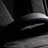 A black backpack featuring padded straps and textured fabric, with a small logo visible.