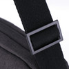 A black shoulder strap buckle featuring a textured fabric. The strap connects to a dark grey bag.
