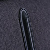A close-up of a dark grey fabric with a black leather accent, part of the Swissdigital Arosa Duffle Bag.