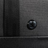 A black duffle bag with a textured surface and a circular logo on the side.