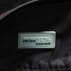 A close-up of the interior of a black duffle bag featuring a branded logo tag.