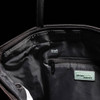An interior view of a black tote bag featuring RFID protection, a zip pocket, and branding.