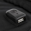 A close-up of a black USB port attached to a backpack, featuring a small branding logo.