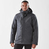 A dark grey men's jacket with a hood, featuring a zip front and an exterior pocket, displayed on a model.