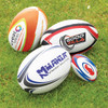 A collection of four rugby balls in various designs and colours, resting on green grass. Each has unique branding.