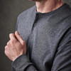 A grey long-sleeve Henley shirt with a two-button placket and fitted sleeves. It features a subtle logo.
