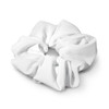 A white hair scrunchie with a textured fabric design, featuring a circular shape and soft pleats.