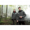 A man and woman wearing grey Bryce Insulated Softshell Jackets stand in a misty forest. The jackets have logos.