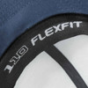 A cap featuring a navy blue colour with an inner label marked "FLEXFIT 110" and a logo.