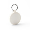 A white keychain with a circular design and a silver metal ring. The keychain features a subtle textured pattern.