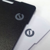 A carbon Bluetooth tracker featuring a black and a white side, both with branding logos.