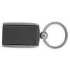 A carbon fibre keychain in black with a silver ring and a sleek design. It features a logo on one side.