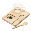 A clear glass cup sits on a bamboo tray with a wooden spoon, featuring a logo on the tray.