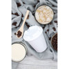 A 350mL white cup with a lid, surrounded by coffee beans, a wooden spoon, and drinks on a grey fabric backdrop.
