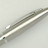 A metal pen in silver with a shiny finish and a clip, featuring a logo.