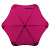 A fuchsia umbrella with a unique star shape and a central button, featuring a black logo.
