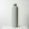 A drink bottle in a sleek, light grey finish, featuring a grey screw-top lid and a minimalist design.