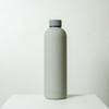 A drink bottle in matte grey with a screw-top lid and a minimalist design. It features a logo on the side.