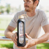 A drink bottle with a sleek black design and a wooden lid, featuring a measurement scale and a logo.