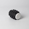A black and white Whirl Popper Spinner featuring raised bumps on its surface, designed for interactive play.