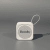 A compact white portable Bluetooth speaker with a loop for attachment. Features a logo on the front.