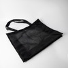 A black nylon mesh tote bag with two handles rests on a light background. It features a textured pattern.