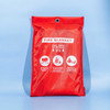 A red fire blanket in a protective bag featuring a logo and illustrated instructions for use.