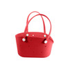 A red EVA bag with holes and two handles, featuring contrasting white buttons. It has a streamlined, modern design.