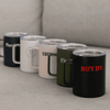 A collection of five travel mugs in navy, white, blush, olive, and black, featuring various logos.