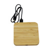 A bamboo wireless charging dock in a square shape, featuring a black charging cable attached.