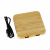 A bamboo wireless charging dock with two USB ports and a black charging cable.