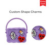 A purple silicone bag featuring custom shape charms, with a handle and multiple holes for design.