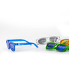 A pair of blue sunglasses alongside green, orange, and clear sunglasses, featuring a logo on the blue pair.