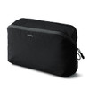 A black packing cube with a zippered mesh top, featuring branding on the front.