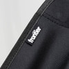 A black fabric showing stitching and a logo tag for a folding chair.