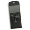 A black leather manicure set containing scissors, nail clippers, and a file, stored in a compact case with a snap closure.