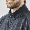 A grey full zip fleece jacket with a stand-up collar, featuring a branding logo and a textured fabric.