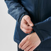 A navy thermal jacket featuring elastic cuffs, with a person's hand adjusting the sleeve. The jacket has a logo.
