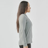 A women's long-sleeve polo shirt in grey, featuring a collar and a fitted design, with a visible logo.