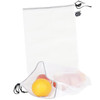 A lightweight, white produce bag with a drawstring carrying a yellow orange and several apples inside.