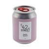 A pink can-shaped candle with a silver lid, featuring a label for 'Vanilla Caramel' fragrance and a logo.