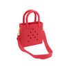 A mini beach bag in bright pink with cut-out holes and dual handles, featuring an adjustable shoulder strap.